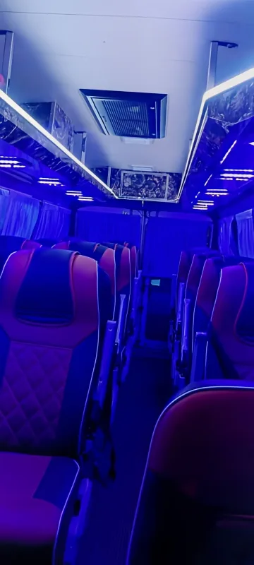 17-seater AC Tempo Traveller interior view at night with ambient lighting