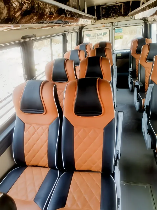Daytime interior shot of 17-seater Tempo Traveller AC seats